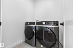 Laundry area featuring baseboards and washer and clothes dryer - 