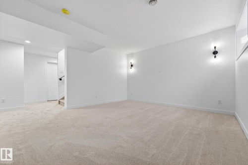 Spare room featuring light colored carpet, stairs, and recessed lighting - 132 Heron Point Close, Rural Wetaskiwin County, AB - Indoor Photo Showing Other Room