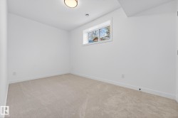 Empty room with light carpet and baseboards - 