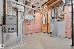 Utilities with water heater, electric panel, and heating unit - 