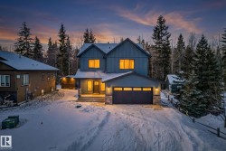 View of front of property with board and batten siding and stone siding - 
