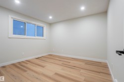 Spare room featuring wood finished floors and recessed lighting - 