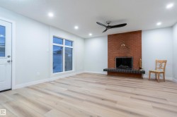 Unfurnished living room featuring a fireplace, light wood-style floors, ceiling fan, and recessed lighting - 
