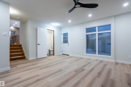 Unfurnished living room with light wood-style flooring, ceiling fan, stairs, and recessed lighting - 47 Manor Drive, Sherwood Park, AB - Indoor Photo Showing Other Room