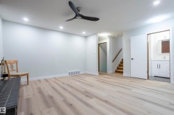 Unfurnished room with light wood-style flooring, a ceiling fan, stairs, and recessed lighting - 
