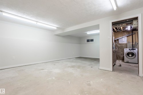 Basement featuring washer / clothes dryer and a textured ceiling - 47 Manor Drive, Sherwood Park, AB - Indoor Photo Showing Basement