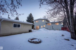 Snow covered property with stucco siding - 