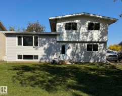 Back of house featuring a lawn - 