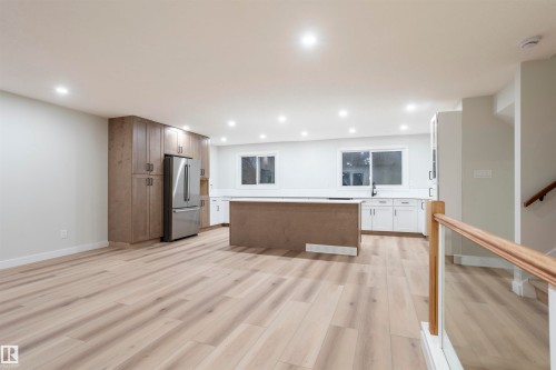 Kitchen with light wood finished floors, a center island, freestanding refrigerator, recessed lighting, and open floor plan - 47 Manor Drive, Sherwood Park, AB - Indoor Photo Showing Other Room