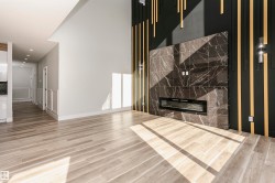 Unfurnished living room with LVP finished floors, a premium fireplace, and recessed lighting - 