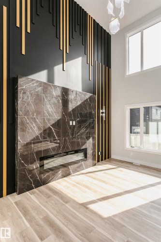 Detailed view of LVP finished floors and a premium fireplace - 1723 19 Street, Edmonton, AB - Indoor Photo Showing Other Room