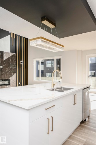 Kitchen with white cabinets, light stone counters, dishwasher, light wood-style floors, and modern cabinets - 1723 19 Street, Edmonton, AB - Indoor Photo Showing Kitchen With Double Sink