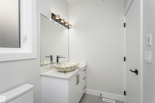 Bathroom featuring vanity and light tile patterned flooring - 1723 19 Street, Edmonton, AB - Indoor Photo Showing Other Room