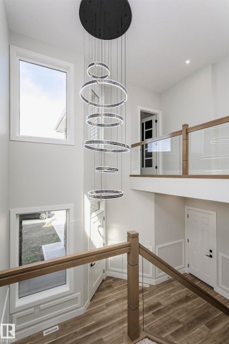 Unfurnished dining area with dark wood-style floors, recessed lighting, and a chandelier - 1723 19 Street, Edmonton, AB - Indoor Photo Showing Other Room