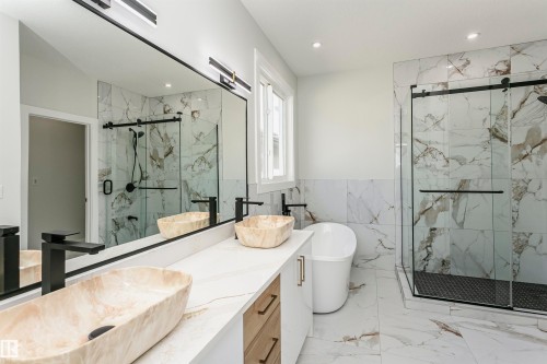 Full bath featuring a marble finish shower, vanity, light marble finish flooring, a soaking tub, and wainscoting - 1723 19 Street, Edmonton, AB - Indoor Photo Showing Bathroom