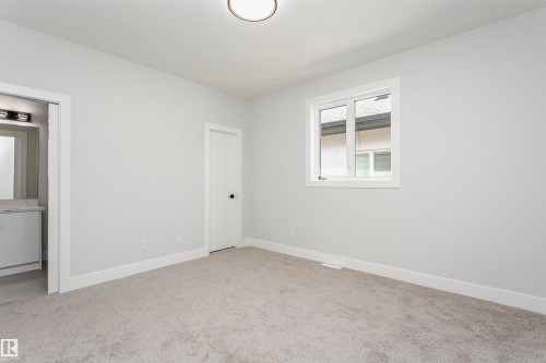 Unfurnished bedroom featuring baseboards and light colored carpet - 1723 19 Street, Edmonton, AB - Indoor Photo Showing Other Room