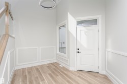 Entryway featuring light wood-type flooring and a decorative wall - 