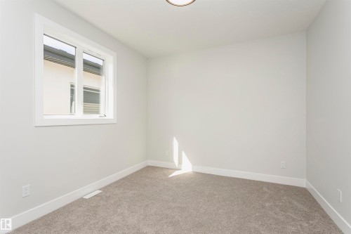 Empty room featuring light carpet and baseboards - 1723 19 Street, Edmonton, AB - Indoor Photo Showing Other Room
