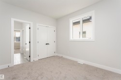 Unfurnished bedroom featuring light colored carpet and a closet - 