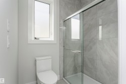 Full bath featuring a shower stall and toilet - 