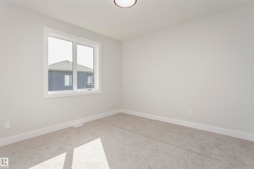 Unfurnished room featuring carpet floors and baseboards - 1723 19 Street, Edmonton, AB - Indoor Photo Showing Other Room
