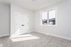 Unfurnished bedroom with light carpet and a closet - 