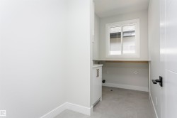Laundry room with baseboards and a desk - 