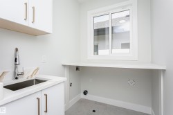 Laundry featuring cabinet space and hookup for a washing machine - 