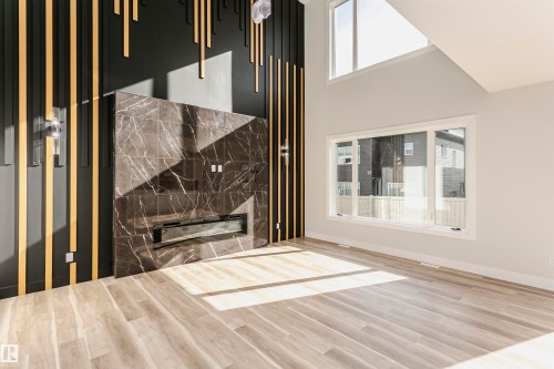 Interior space with LVP finished floors and a premium fireplace - 1723 19 Street, Edmonton, AB - Indoor Photo Showing Other Room
