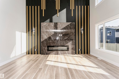 Detailed view of LVP finished floors and a fireplace - 1723 19 Street, Edmonton, AB - Indoor Photo Showing Other Room With Fireplace