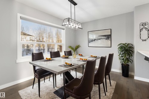 Dining area with dark wood finished floors and baseboards - 107 Cresthaven Grove, Ardrossan, AB - Indoor Photo Showing Dining Room