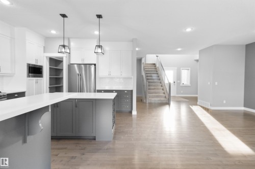 Kitchen with pendant lighting, stainless steel appliances, white cabinets, gray cabinets, and recessed lighting - 107 Cresthaven Grove, Ardrossan, AB - Indoor Photo Showing Kitchen With Stainless Steel Kitchen With Upgraded Kitchen