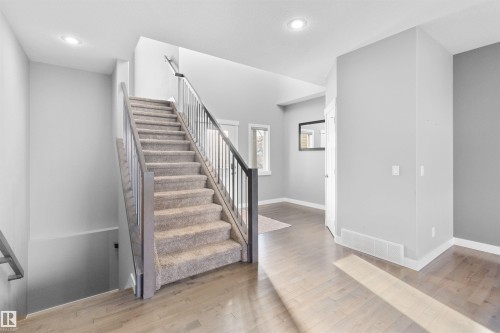 Stairway with wood-type flooring and recessed lighting - 107 Cresthaven Grove, Ardrossan, AB - Indoor Photo Showing Other Room