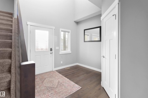 Foyer featuring stairs, dark wood-type flooring, and a high ceiling - 107 Cresthaven Grove, Ardrossan, AB - Indoor Photo Showing Other Room