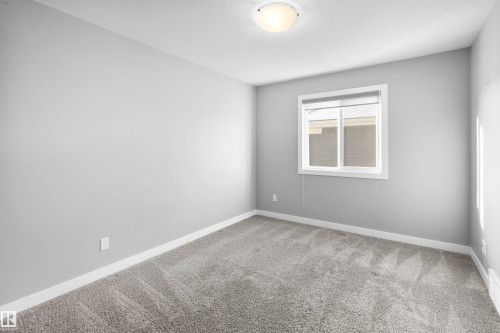 Carpeted spare room with baseboards - 107 Cresthaven Grove, Ardrossan, AB - Indoor Photo Showing Other Room