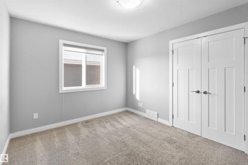 Unfurnished bedroom featuring carpet floors and a closet - 107 Cresthaven Grove, Ardrossan, AB - Indoor Photo Showing Other Room