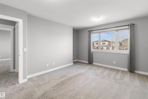Unfurnished room with light carpet and baseboards - 107 Cresthaven Grove, Ardrossan, AB - Indoor Photo Showing Other Room