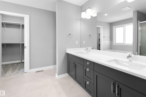 Bathroom with double vanity, a stall shower, a walk in closet, and a bath - 107 Cresthaven Grove, Ardrossan, AB - Indoor Photo Showing Bathroom