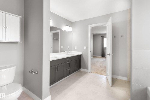 Bathroom featuring double vanity and baseboards - 107 Cresthaven Grove, Ardrossan, AB - Indoor Photo Showing Bathroom