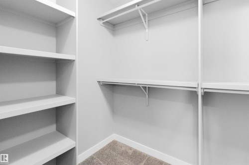 Walk in closet with light colored carpet - 107 Cresthaven Grove, Ardrossan, AB - Indoor With Storage