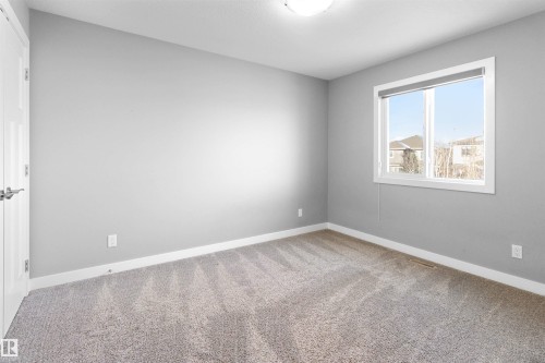 Unfurnished room with light colored carpet and baseboards - 107 Cresthaven Grove, Ardrossan, AB - Indoor Photo Showing Other Room