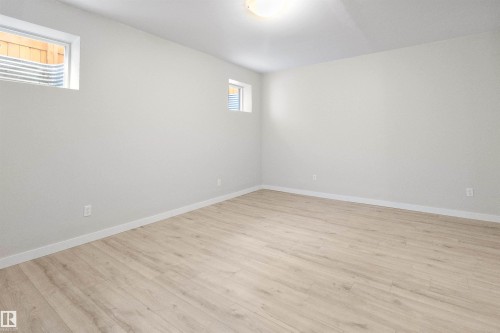 Unfurnished room with light wood-type flooring and baseboards - 107 Cresthaven Grove, Ardrossan, AB - Indoor Photo Showing Other Room