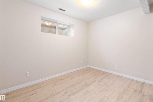 Empty room featuring light wood finished floors and baseboards - 107 Cresthaven Grove, Ardrossan, AB - Indoor Photo Showing Other Room
