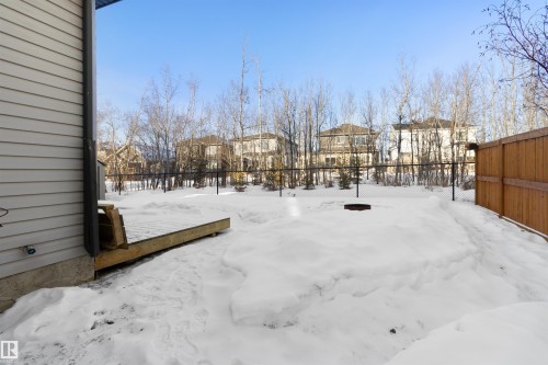 Yard covered in snow featuring a residential view and a deck - 107 Cresthaven Grove, Ardrossan, AB - Outdoor With Exterior