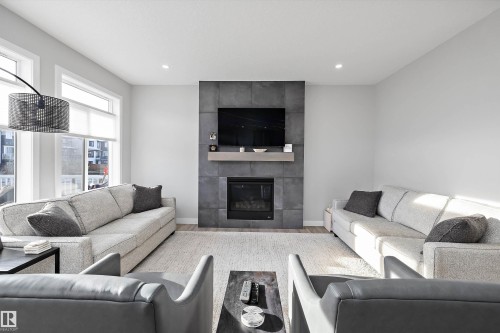 7027 54 Avenue, Beaumont, AB - Indoor Photo Showing Living Room With Fireplace