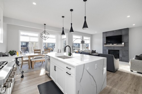 7027 54 Avenue, Beaumont, AB - Indoor Photo Showing Kitchen With Fireplace With Upgraded Kitchen