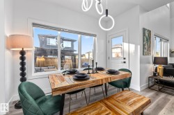 Dining space featuring light wood-style flooring and plenty of natural light - 