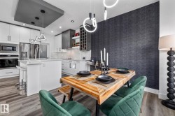 Dining room featuring light wood-type flooring, recessed lighting, and wallpapered walls - 