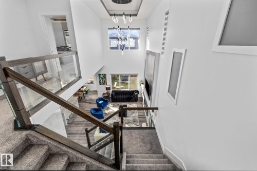Staircase with carpet, a towering ceiling, and a chandelier - 5304 Kimball Place, Edmonton, AB - Indoor Photo Showing Other Room