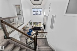 Staircase with carpet, a towering ceiling, and a chandelier - 